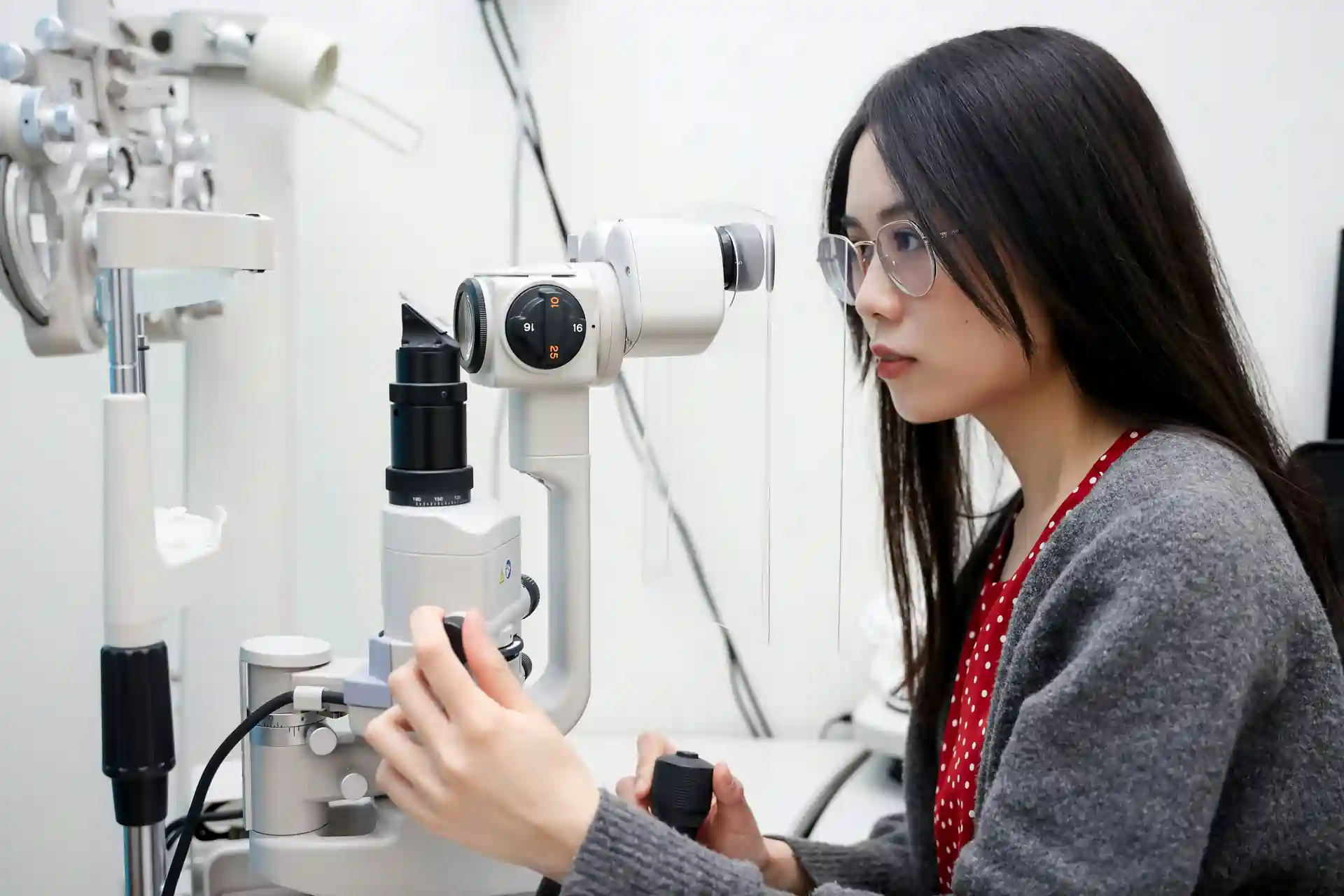 Woman looking into a microscope